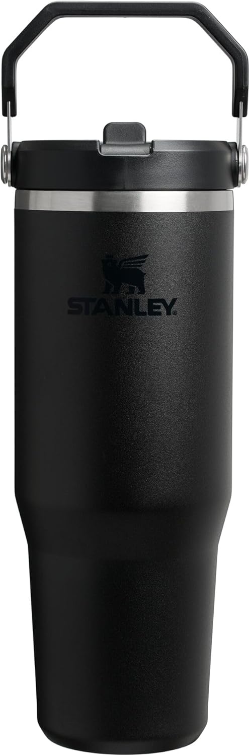 Black Stanley tumbler with handle on a white background
