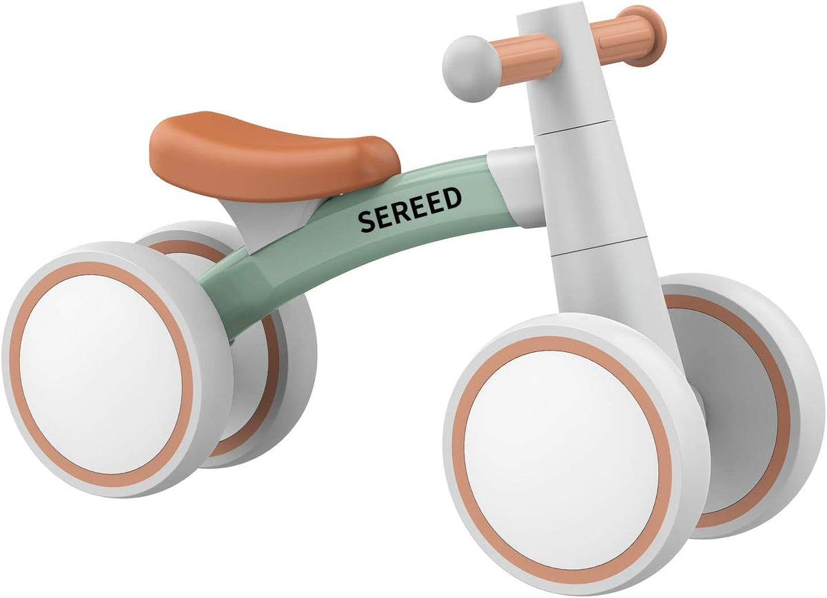 A modern balance bike with a white frame, white wheels with tan accents, a mint green handlebar bar, and a tan seat. The brand name 'SEREED' is printed on the handlebar bar.